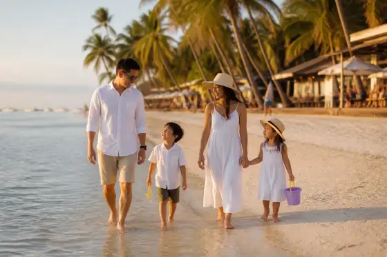 Family walking on Alona Beach in Panglao at sunset