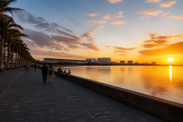 Manila Bay waterfront near Mall of Asia at sunset with promenade and city skyline