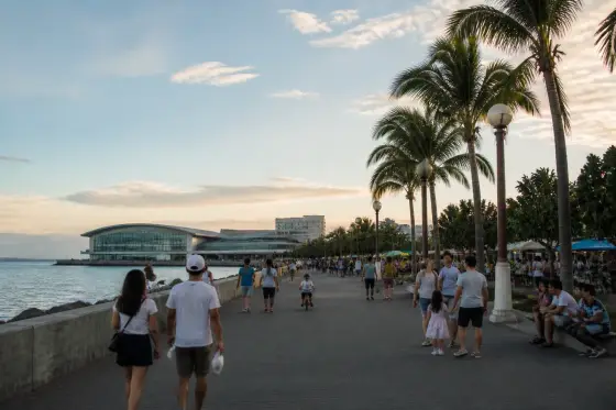 People walking along the Mall of Asia waterfront promenade in Pasay