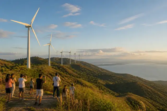 Wind turbines on rolling hills above Laguna de Bay at Pililla Wind Farm