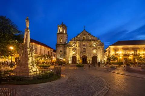 Plaza Salcedo with St. Paul Cathedral and basin at dusk in Vigan