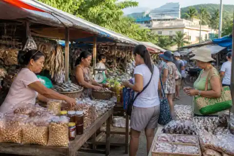 Puerto Princesa market stalls with vendors selling cashews, dried seafood and souvenirs