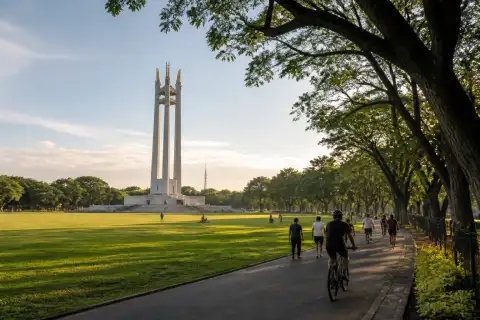 Quezon Memorial Circle lawns and shrine with visitors walking and cycling