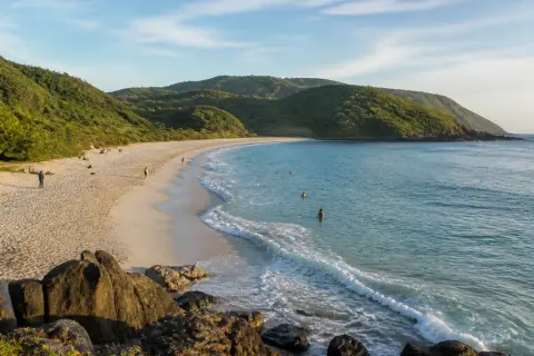 Pale-sand curve of Darigayos Cove in La Union at morning light
