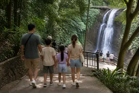 Family walking toward Hinulugang Taktak waterfall viewing area in Antipolo
