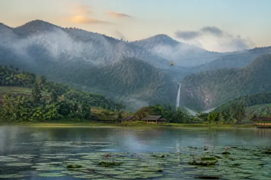 Dawn view of Lake Sebu with lotus-covered lake and distant waterfall valley