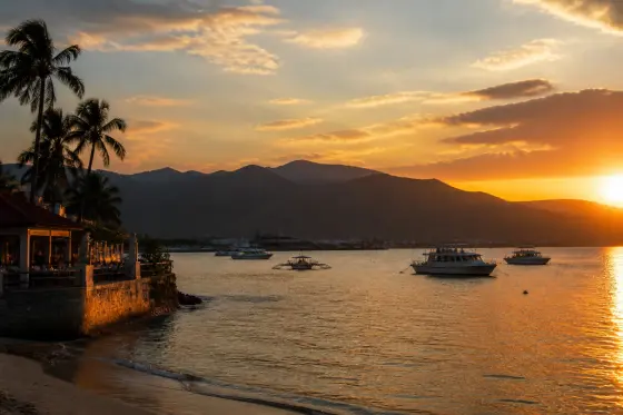Sunset over Subic Bay with Baloy shoreline and silhouetted Zambales mountains