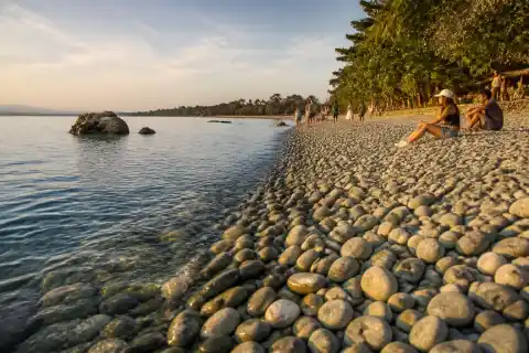 Pebble shoreline at Mabua Pebble Beach near Surigao City at sunset