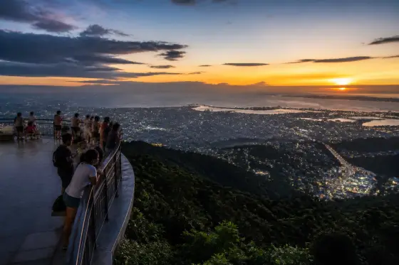 Visitors on TOPS Cebu observation deck watching sunset over Cebu City