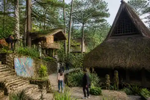 Tam-Awan Village hillside with reconstructed Cordillera houses and visitors