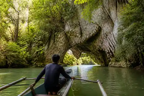 Boat approaching limestone natural bridge and cave at Sohoton, Basey, Samar