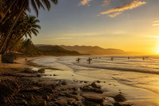 Sabang Beach sunrise in Baler with silhouetted surfers